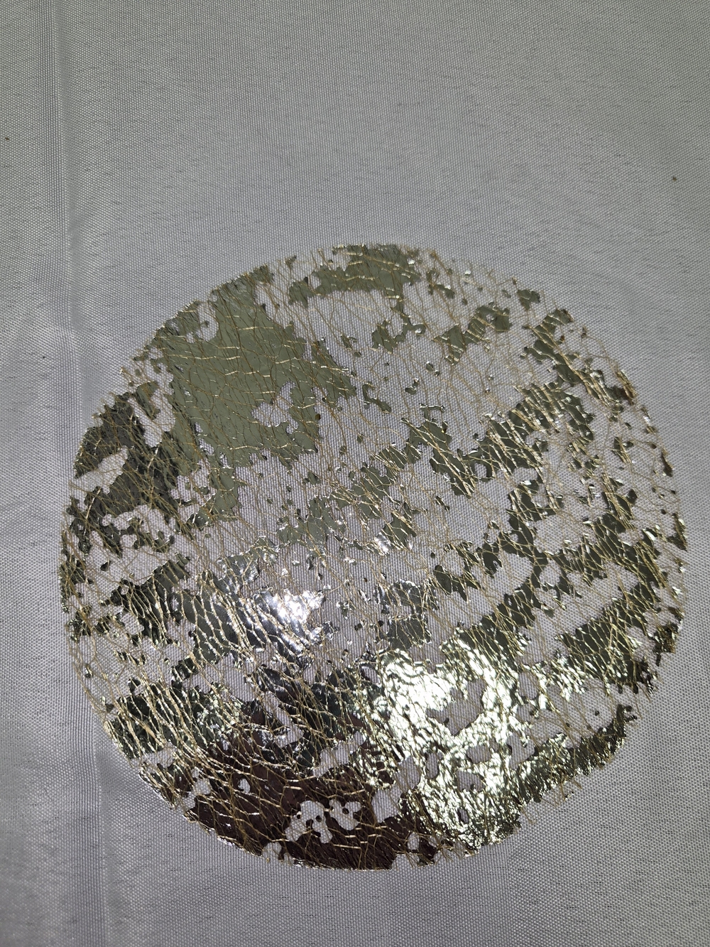 round, metallic gold and silver mesh-pressed disposable placemats